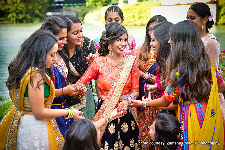 Indian Bride Showing her Lovely Mehndi Design to Bridesmaids